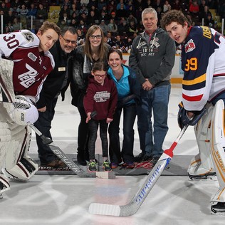 A young girl makes the ceremonial puck drop